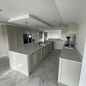 a large kitchen with a marble counter top