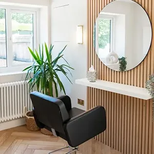 a chair in a room with a mirror on the wall